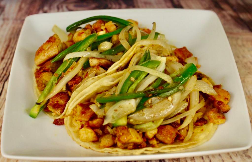 Taco Acorazado · regular tortilla serve with rice choice of mean and topped off with sautéed jalapenos and onios