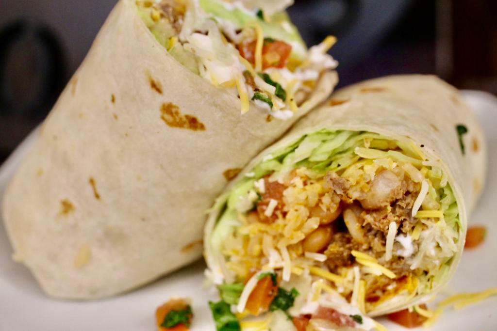 Burrito · Spanish rice, pinto beans, sour cream, cheese,  lettuce, pico de gallo, and house salsa. choice of meat