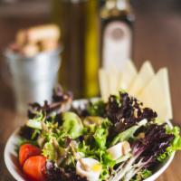 Capricciosa Salad · Mixed greens, hearts of palm, tomatoes, Italian dressing and Parmesan shaves.