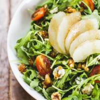 Rucola Salad · Baby organic arugula, pears, roquefort cheese, caramelized walnuts, balsamic vinegar and oli...