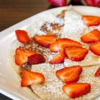 Strawberry Crepe · Thin crepe with Nutella spread, fresh cut strawberries, dust of powder sugar and chocolate d...