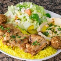 Large Piece of Grilled Chicken Plate · Over seasoned rice, served with house salad, pita bread and 2 falafel balls.