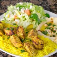 Chicken Kabob Plate · 2 skewers over seasoned rice served with hummus, house salad, and pita bread.