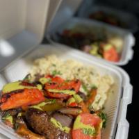 Lomo Saltado with Rice · Sirloin steak, onions, tomatoes, bell peppers, French fries, cilantro, aji verde sauce and P...
