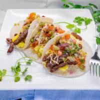 Regular Breakfast Tacos · 2 eggs, cheese, bacon or sausage on 2 tortillas
