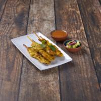 Chicken Satay · 5 Skewers of marinated chicken served with peanut sauce and cucumber.