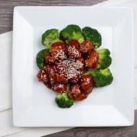 67. Sesame Chicken · Crispy chunk of chicken with broccoli and sesame seeds in a brown sauce.