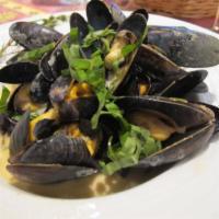 Mussels Scampi Pasta · P.E.I. mussels sauteed with white wine, garlic, oil and served over linguine. Served with ho...