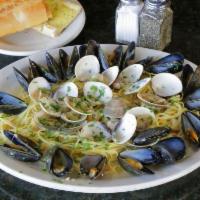 Mussels and Clams Pasta · P.E.I. mussels and little neck clams served over pasta. Served with house salad and garlic b...