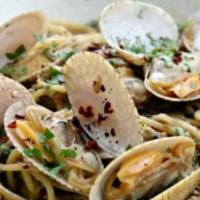 White Clam Sauce Pasta · Clams sauteed with white wine, garlic, oil and served over linguine. Served with house salad...