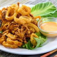 Cajun Calamari · Crispy fried calamari with a zest of cajun seasoning topped with fresh parsley served with c...