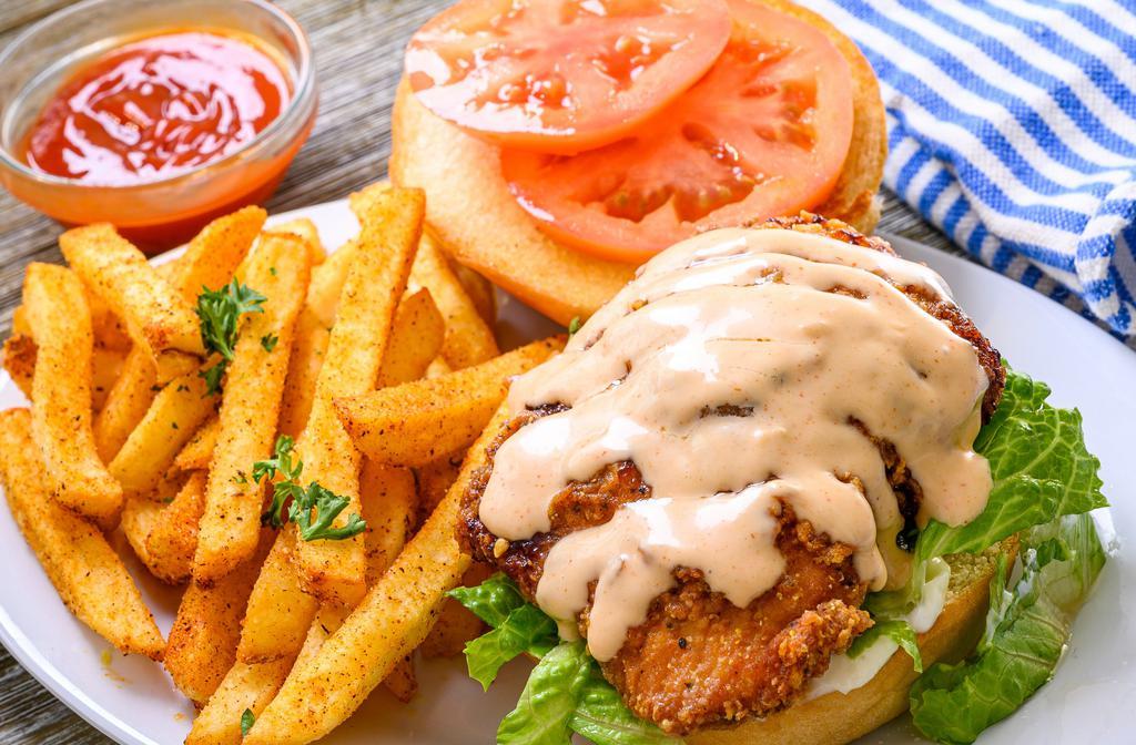 Cajun Spicy Chicken Sandwich ·  Crispy juicy cajun chicken served on a soft brioche bun with mayo, pickles, fresh cut lettuce, sliced tomatoes, and topped with our house spicy honey dipping sauce
Served with fries
