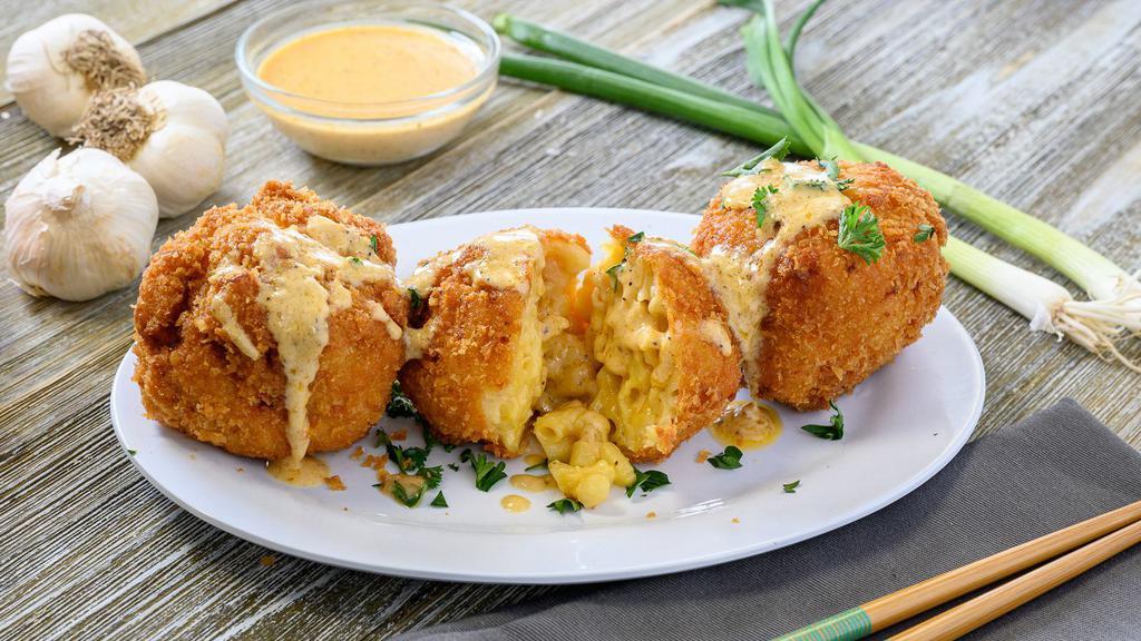 Cajun Fried Mac & Cheese · Cheesy macaroni rolled up and fried, served with creole cream sauce.