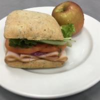 Turkey Sandwich · Sliced Turkey with mayo, lettuce, tomato, and red onion on Focaccia bread. Comes with 1 side.