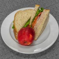 Tuna Sandwich · House made tuna salad, lettuce, tomatoes, and red onion on whole grain bread. Comes with 1 c...