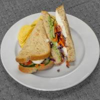 Veggie Sandwich · Cucumber, roasted tomatoes, feta cheese, carrot, red cabbage,  mayo, and house made herb eda...