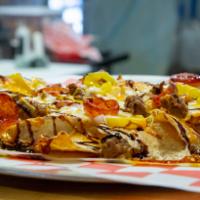 Borrachos Nachos · Loaded with mozzarella and a hint of cheddar cheese, topped with Italian sausage, pepperonci...