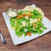 Caesar Salad · Crisp romaine lettuce, homemade croutons, shaved Parmesan cheese, and creamy Caesar dressing.