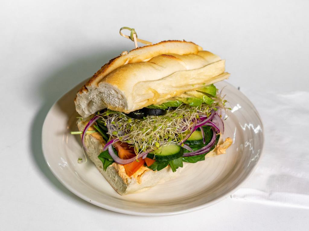 Green Karma Sando · Roasted red pepper cream cheese spread, Spinach, tomato, avocado, sprouts, black olives, cucumber, red onion, banana pepper, roasted garlic spread, Dutch crunch.