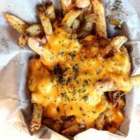 Skillet Fries · House Fries, Grilled onions, Melted American Cheese, House Sauce, Sprinkle of Parsley
