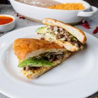 Chicken Tortas · Mexican sandwich served with lettuce, tomato, avocado, beans, cheese, and sour cream.