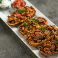 La Reina Lager Tri-Tip Potato Skins · Tri-tip, bacon, cheddar cheese, chives, sour cream, and pico.
