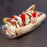 Banana Split · Three of your favorite ice cream flavors, two banana slices ,wet toppings, and sprinkles. 