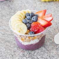 Acai Bowl · Topped with granola, coconut shavings, strawberries, bananas, blueberries, and honey.