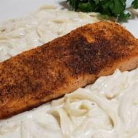 Blackened Salmon Alfredo · Blackened salmon filet topped with a creamy alfredo sauce served over fettuccini.
