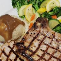 Grilled Pork Chops · 2 seasoned and grilled 8 oz center cut pork chops served with mashed potatoes and mixed vege...