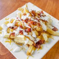 Loaded French Fries · Crispy seasoned french fries delicately smothered with hickory smoked bacon, cheese and driz...