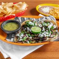 Mexican Street Tacos · 3 corn soft shell steak tacos with onions and cilantro served with  your choice of rice, ref...