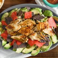 Avocado Chicken Salad · Grilled chicken and slices of fresh avocado over a bed of romaine lettuce with colorful tort...