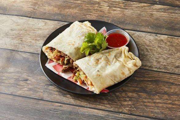 King Breakfast Burrito · A large flour tortilla filled with your Choice of Meat w/ scrambled eggs, beans, lettuce, tomato, sour cream and cheese.