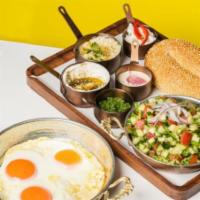Israeli Breakfast · three eggs any style, Israeli salad, labneh, babaganoush, tahini, feta, served with Jerusale...