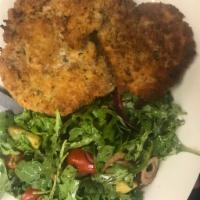 Veal Milanese Salad · Breaded veal cutlets over arugula salad with red onions and tomatoes.