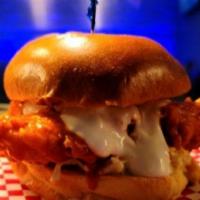 Buffalo Chicken Bun · Crunchy fried chicken tossed in Buffalo sauce, over granny smith coleslaw, topped with blue ...