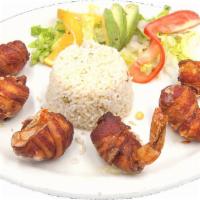 Rellenos · Bacon wrapped shrimp stuffed with cheese. Served with white rice and beans.