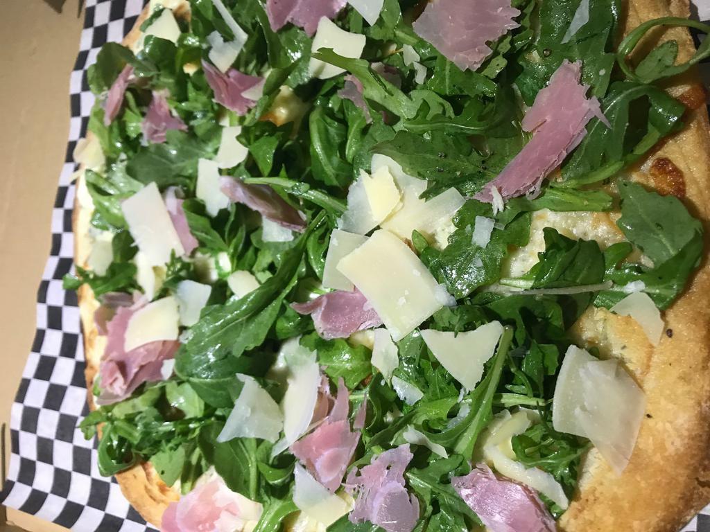 The Arugula, & Prosciutto Pizza · Baby arugula and prosciutto topped with fresh shaved Parmesan cheese.