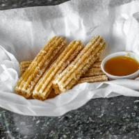 6 Churros · Fried and tossed with cinnamon ＆ sugar. Served with caramel sauce