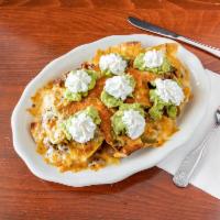 Super Nachos · Crispy corn tortillas. Topped with beans, melted cheese, fresh guacamole, and sour cream. Se...