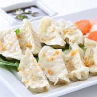 Steamed Dumpling · Chicken or veggie. Served with soy sauce.