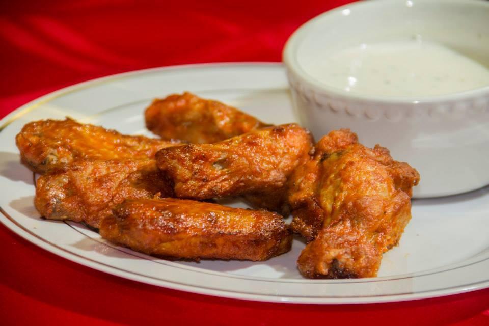 6 Piece Plain Wings · Cooked wings of a chicken coated in sauce or seasoning.