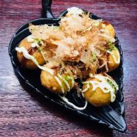 Takoyaki · Grilled pancake balls filled with diced octopus, drizzled with mayo-sauce, sprinkled with bo...