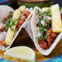 Al Pastor Taco · Classic marinade pork loin with pineapple, onion and cilantro.