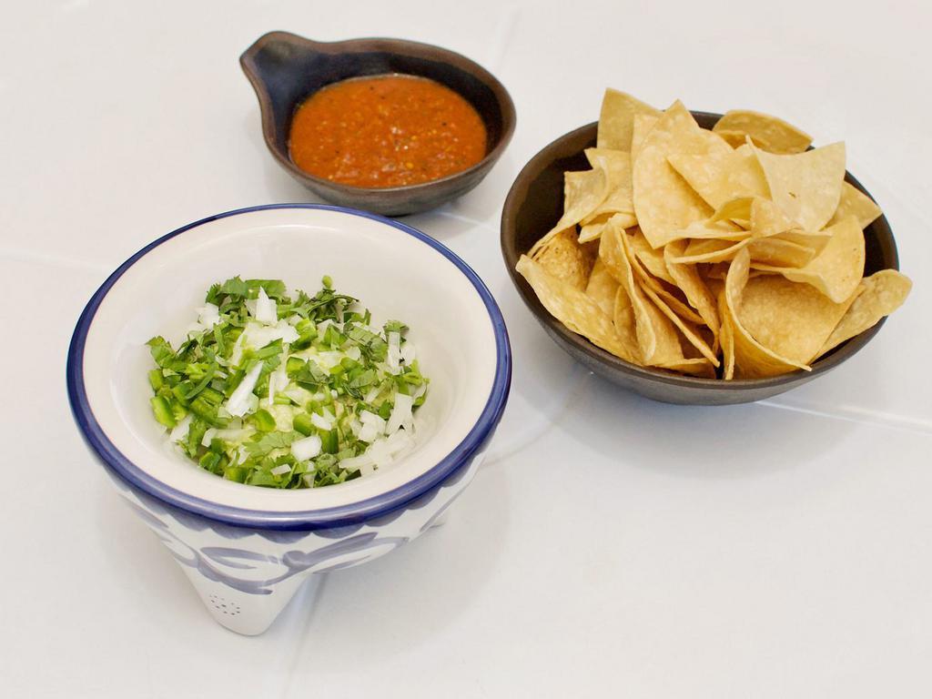 Guacamole · Served with salsa roja and tortilla chips.