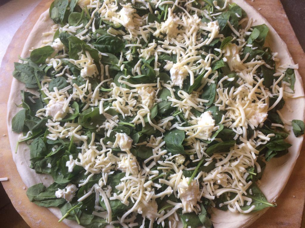 White Spinach Pizza · Spinach, sliced tomatoes, ricotta, mozzarella, romano, olive oil, oregano, and garlic.