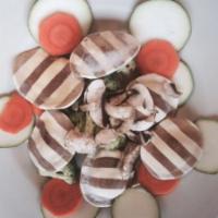 Porcini Mushroom Ravioli · Sauteed with fresh garden vegetables in mushroom marinara sauce. Feeds two people, cooked to...