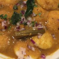 Sambar Mini Idli · Dollar coin sized small steamed rice and lentil patties fried with spicy dhal mix power.
