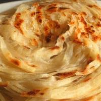 Plain Porotta · 2 pieces of multi layered flat soft bread ,served with choice of gravy ( Salna or Veg Kurma)...